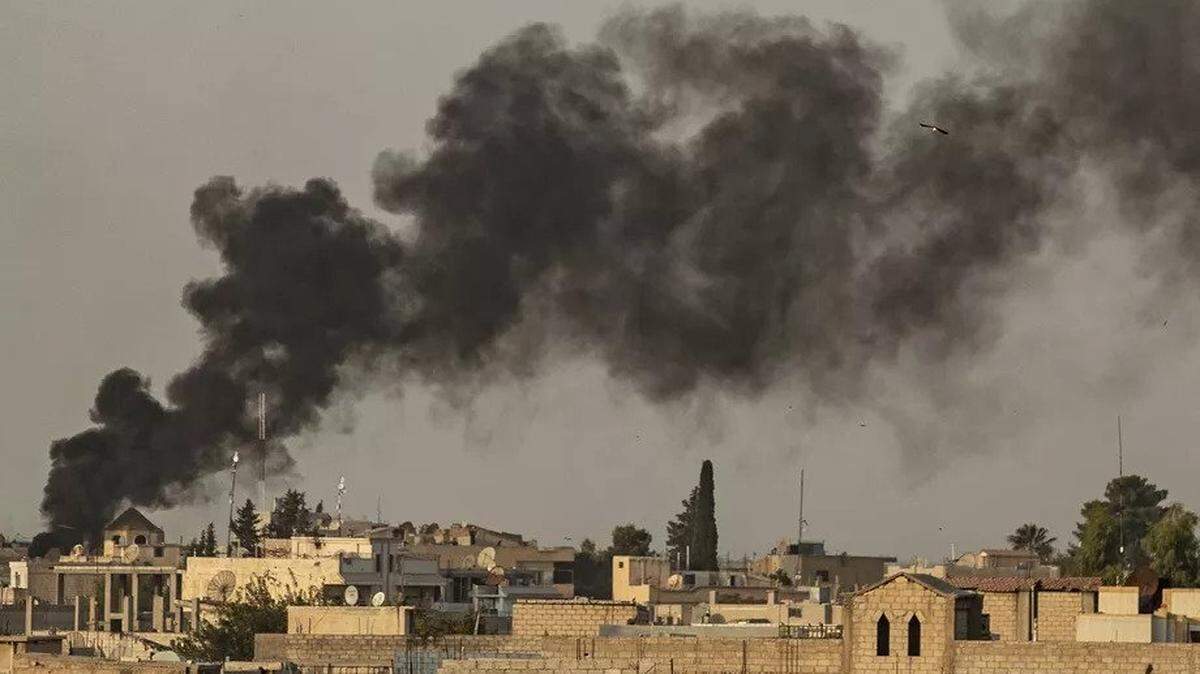 Smoke rises after an apparent Turkish attack on the Syrian border town of Ras al-Ain, a Kurdish stronghold, on Oct. 9.