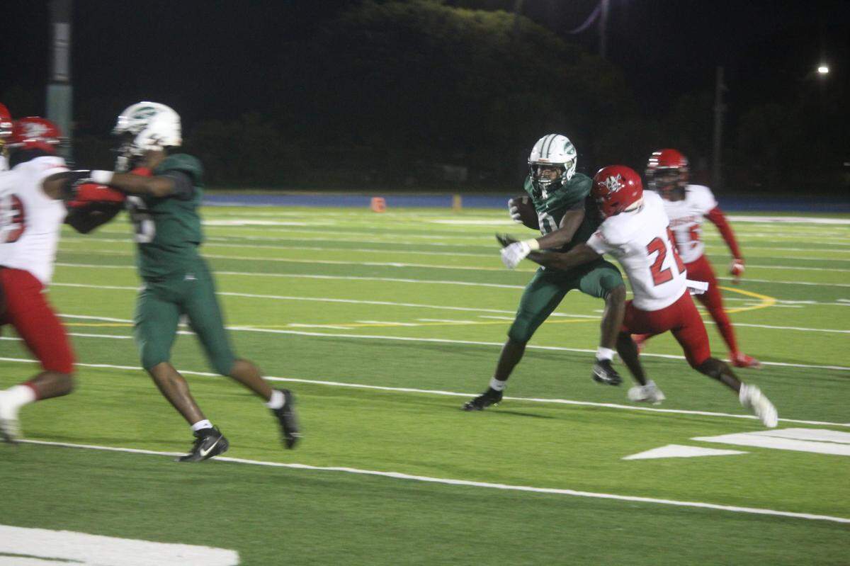 Miami Central running back Jayden Ford tries to shake off a tackler during the Rockets’ Region 4-2M quarterfinal win over Miami Edison on Friday at Traz Powell Stadium.