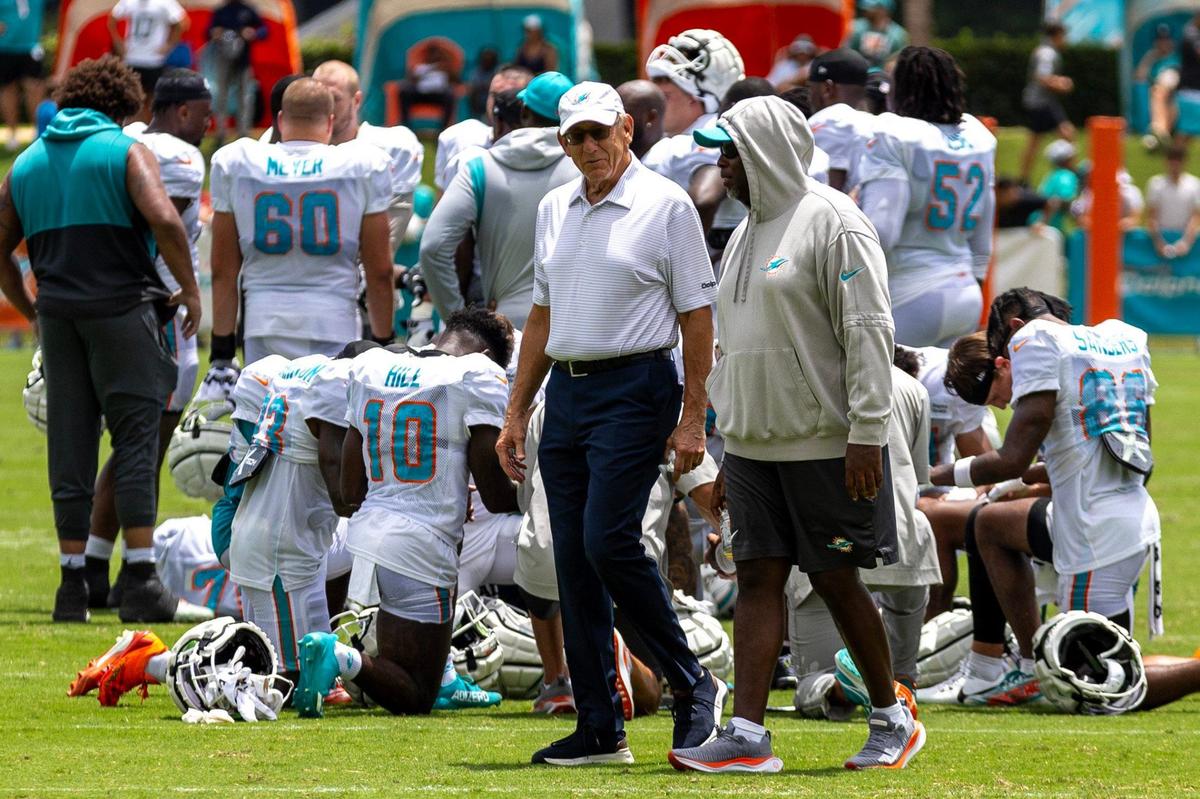 Miami Dolphins owner and chairman Stephen M. Ross, left, walks with general manager Chris Grier, right, during Day 6 of training camp at Baptist Health Training Complex on Tuesday, July 30, 2024, in Miami Gardens, Fla.