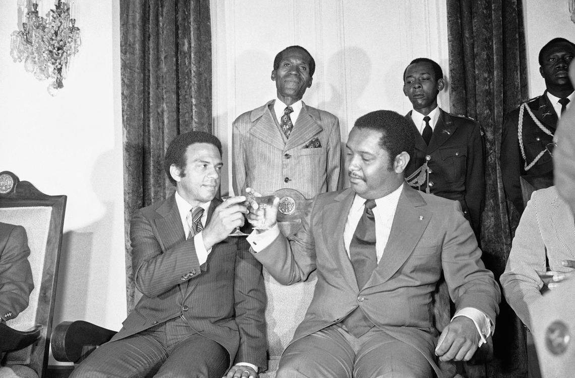 United Nations Ambassador Andrew Young, left, joins Haiti’s President for life Jean-Claude Duvalier in a toast after their meeting Monday, Aug. 15, 1977, in Port-au-Prince, Haiti. Pursuing the Carter administration’s policy of the protection of human rights, Young told Duvalier that “freedom contributes more to stability than repression.”