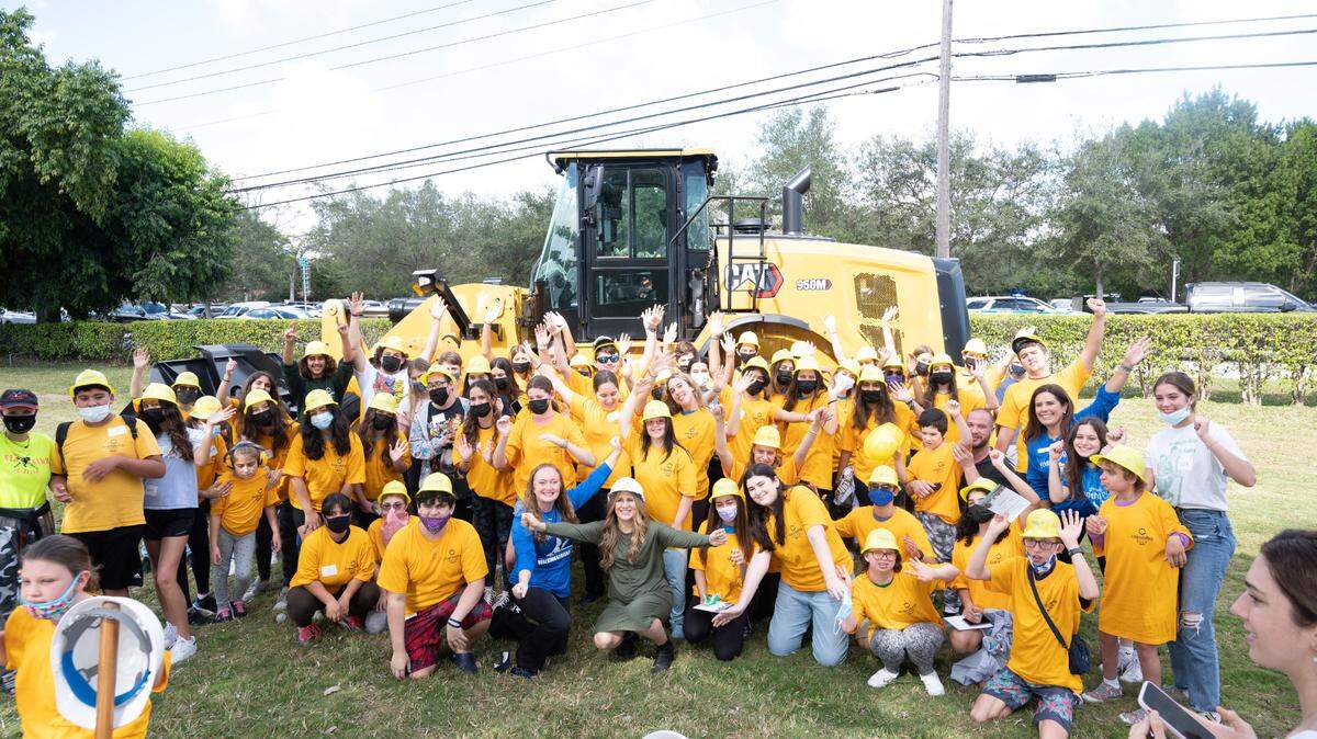 Nechama Harlig, co-director of Friendship Circle in Miami, celebrates at the groundbreaking of the group’s new facility with volunteers and friends.