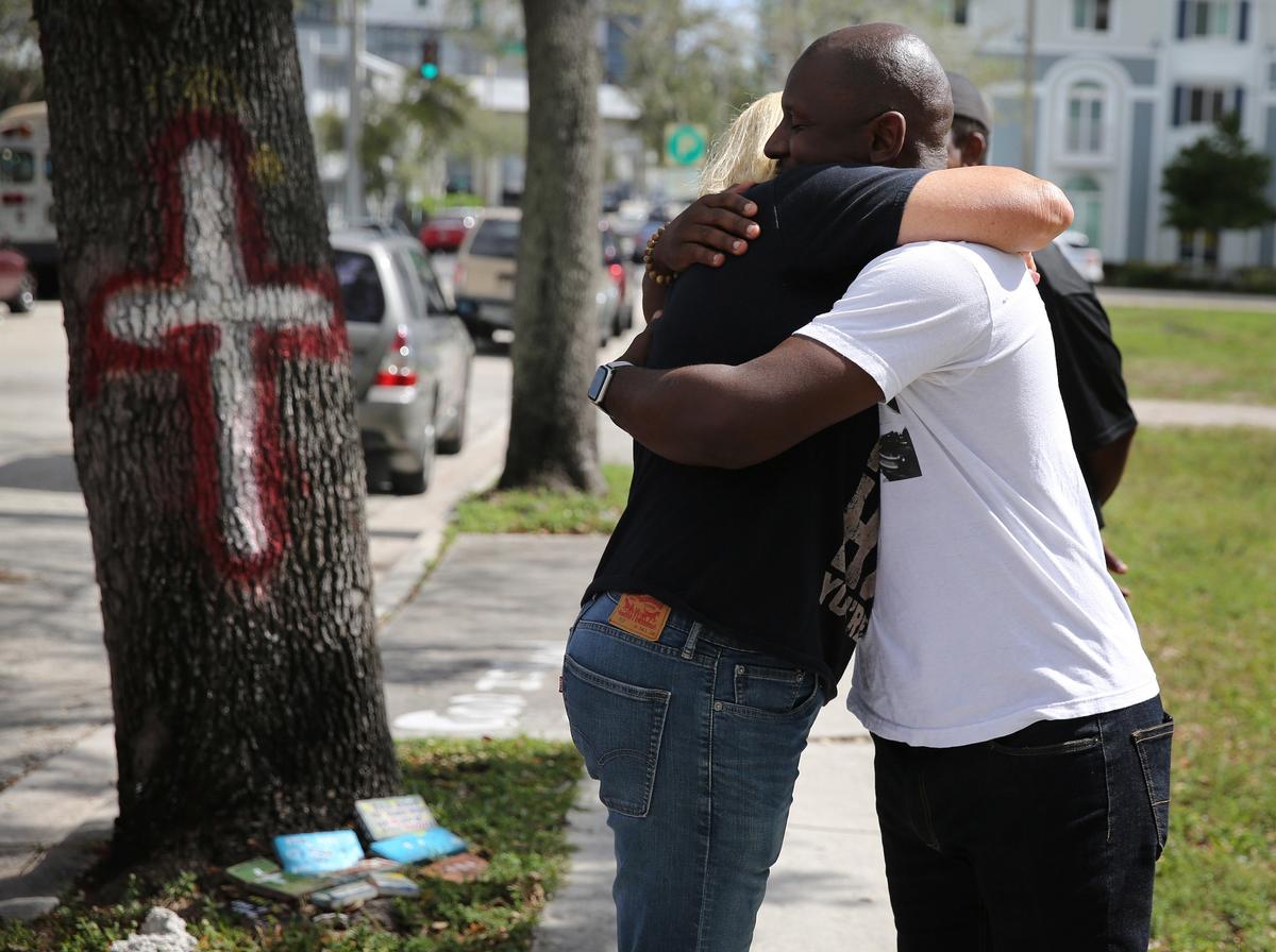 Cindy Dodds, who lost her son Kyle to an overdose, gets a supportive hug from Overtown Community Oversight Advisory Board member Keon Williams near the spot where her son died. Dodds and Williams were discussing problems with homelessness and drug use in the area.