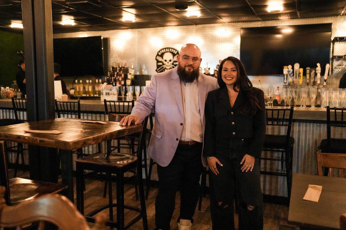 Owners Jeff and Laura Budnechky in the bar area of Apocalypse BBQ at its new location in Kendall Village Center.