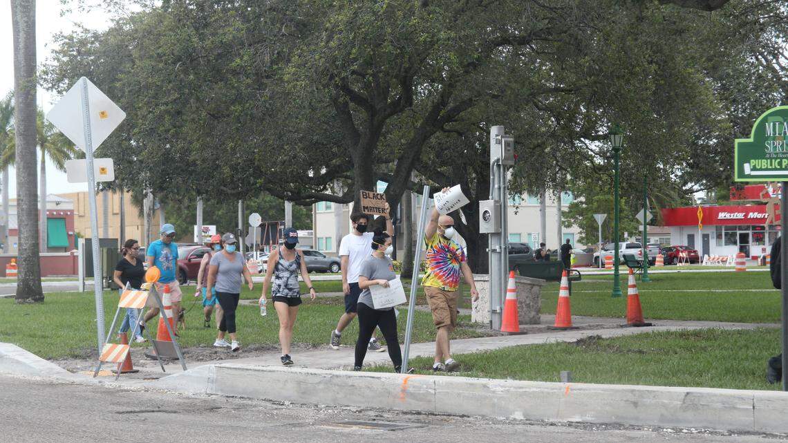 Black Lives Matters protesters walk around the Miami Springs Circle Saturday afternoon, June 6, 2020, calling for the city’s police department to be defunded.