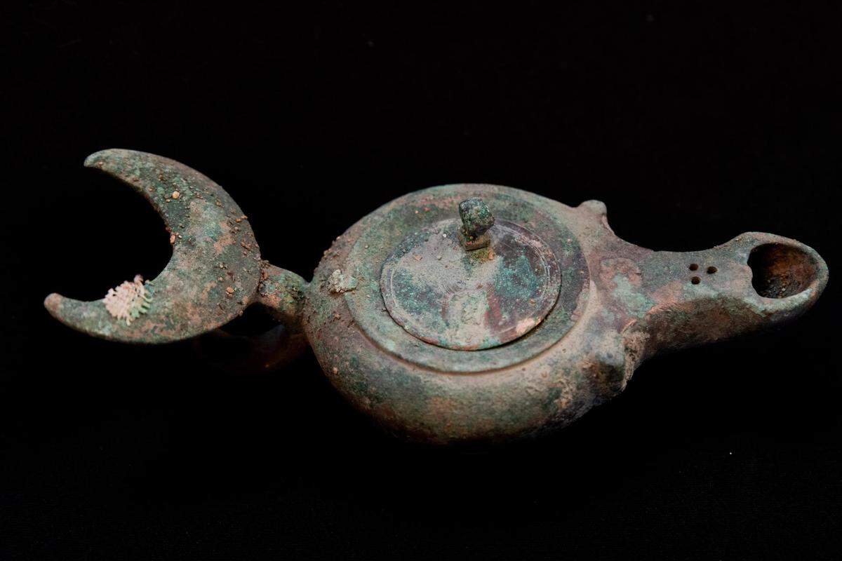 A copper oil lamp.
