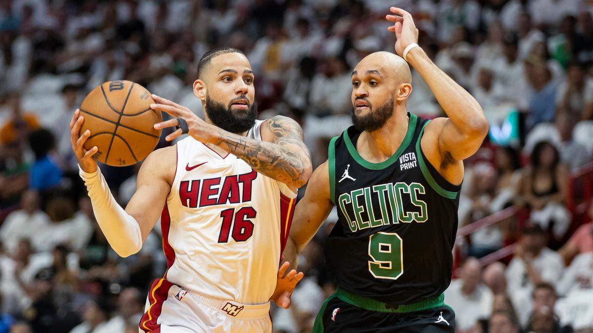 Miami Heat forward Caleb Martin (16) drives the ball as Boston Celtics guard Derrick White (9) defends in the first half of Game 4 of an NBA basketball first-round playoff series at Kaseya Center on April 29, 2024, in Miami.