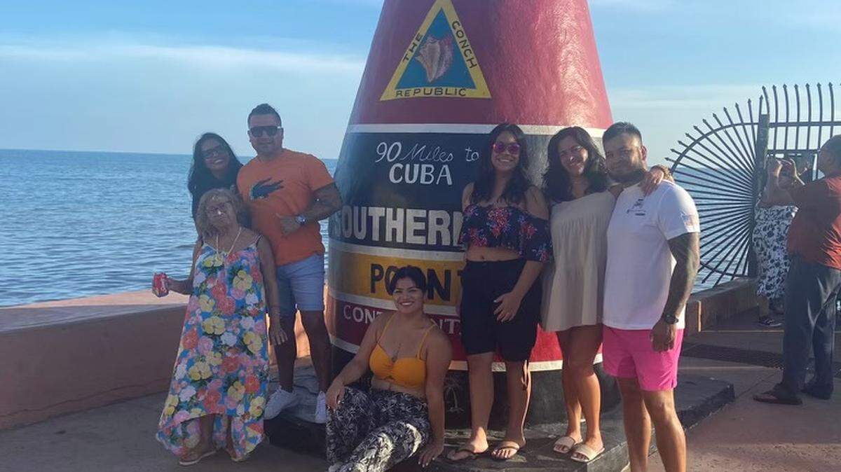 The Hashimoto family, from Miramar and Pembroke Pines, poses for a photo at the Southernmost Point buoy in Key West Sunday, July 17, 2022. Hours later, tragedy struck when their Volkswagen Tiguan SUV was struck by a man police say was driving while drunk on the Seven Mile Bridge. Ompora Elena Huaman, 85, bottom left and holding the Coca-Cola can, was killed in the crash.