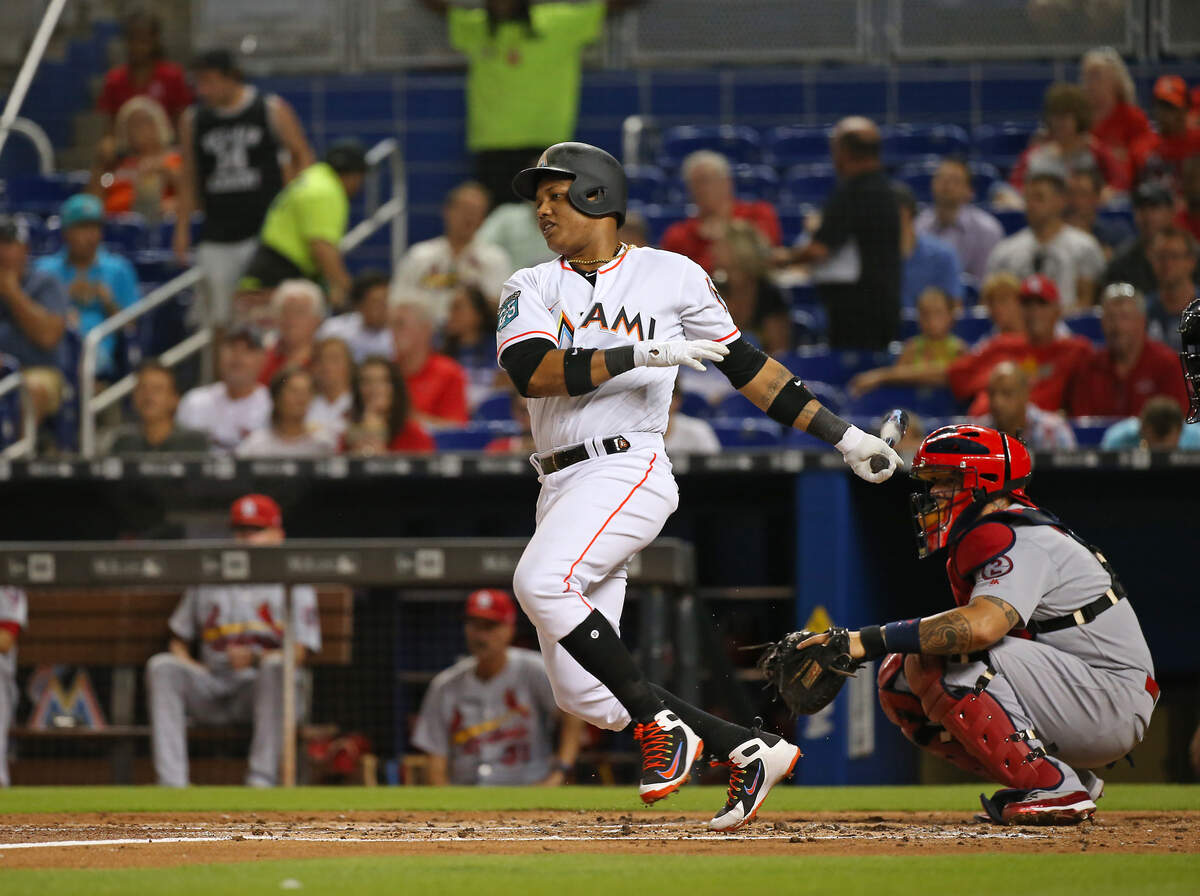 Miami Marlins second baseman Starlin Castro grounds into a force out as he reaches into first base during the second inning of a Major League Baseball game against the St. Louis Cardinals at Marlins Park on Wednesday, August 8, 2018.