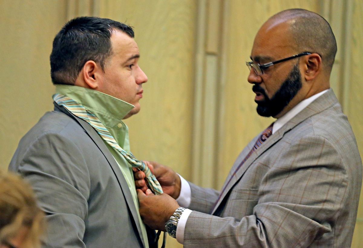 Defendant Orlier Suarez has his tie adjusted by defense attorney Carlos Gonzalez before the trial in DUI manslaughter trial, August 17, 2018.
