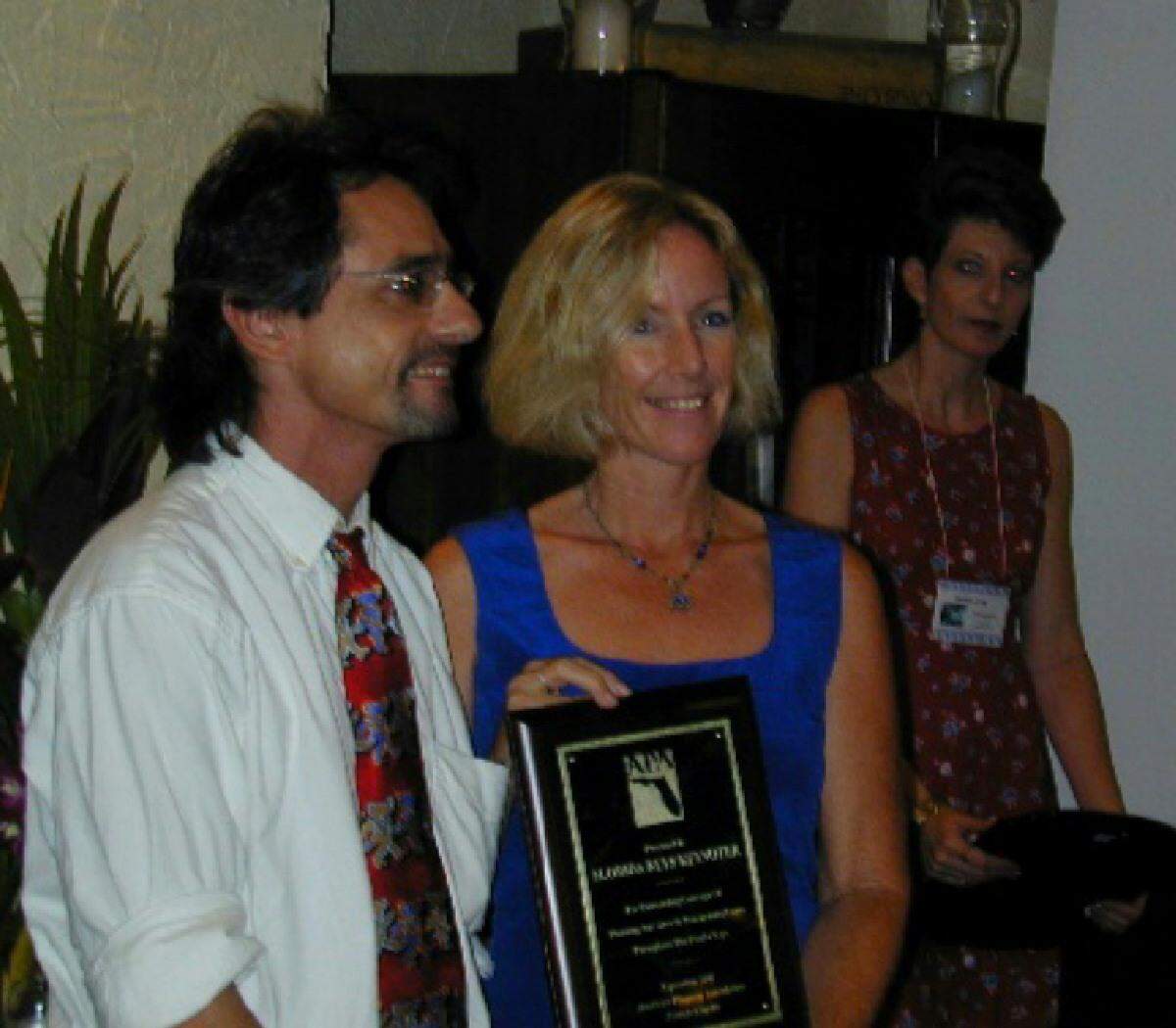 Larry Kahn and Alyson Crean stand in 2006 with one of several Florida Press Association awards the Keynoter newspaper’s staff won over the years.