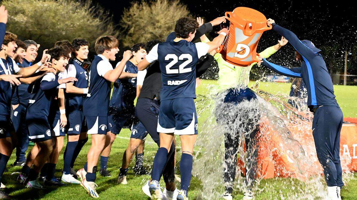 Gulliver Prep players drench their head coach Scott Davidson with a Gatorade bath after winning the Class 4A boys soccer state championship on Saturday at Lake Myrtle Park in Auburndale with a 1-0 win over Orlando Bishop Moore.