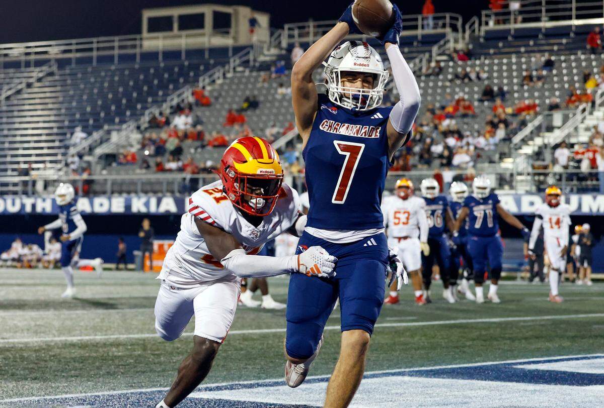Chaminade-Madonna’s Jasen Lopez (7) on a touchdown reception as Clearwater Central Catholic’s Forrest Loving (21) defends in the second half of the Florida High School Football State Championships - Class 1A game at Pitbull Stadium on the campus of Florida International University in Miami, Florida, on Wednesday, December 11, 2024.