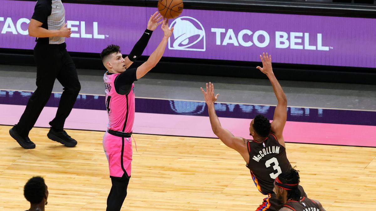 Miami Heat guard Tyler Herro (14) hits a three pointer over Portland Trail Blazers guard CJ McCollum (3) in the fourth quarter of their NBA basketball game at the AmericanAirlines Arena on Thursday, March 25, 2021.