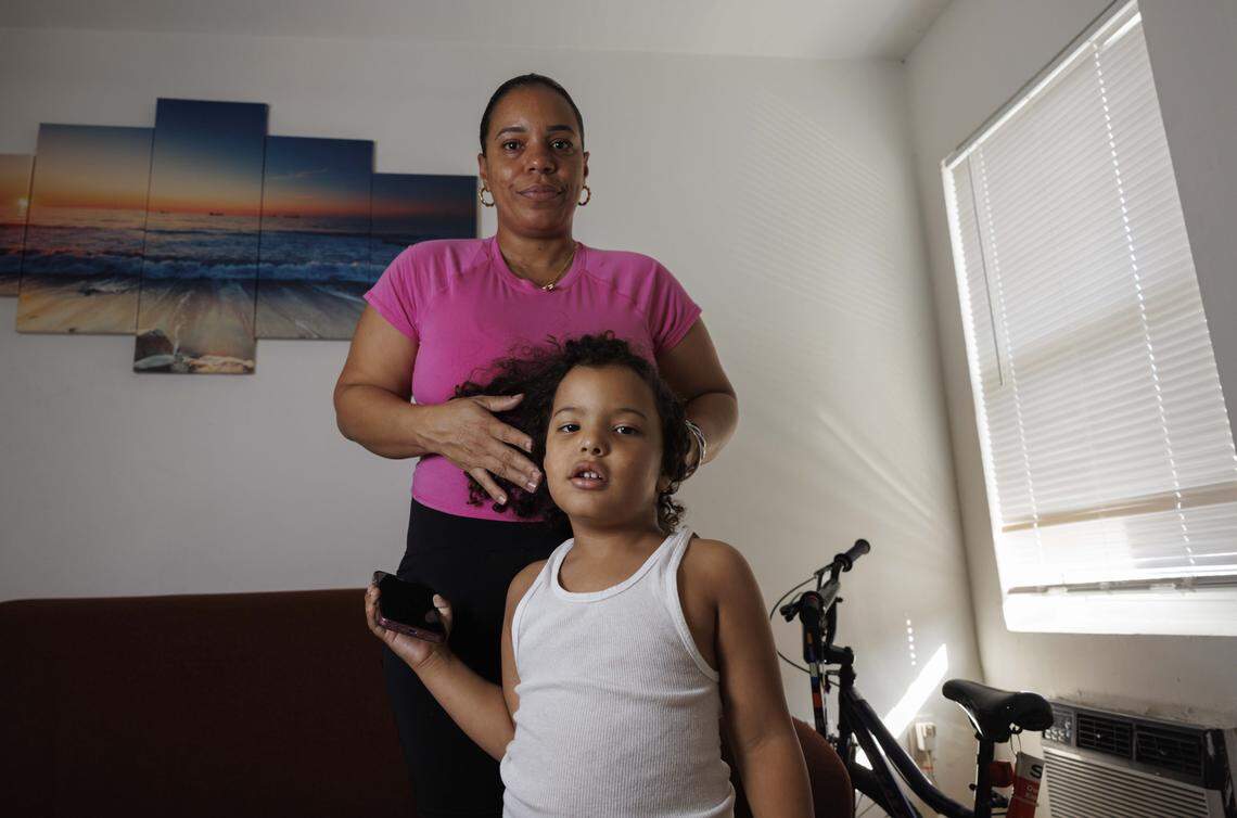 Yudisleine Tejeda Rodriguez plays with her son Alex Tejada's hair, who is autistic, during the afternoon in their home on Wednesday, Oct. 29, 2025, in Overtown Miami. Rodriguez works 40 hours a week, but caring for him as a low income single mother is tough. They will lose SNAP benefits on November 1 if the federal government shutdown continues. 