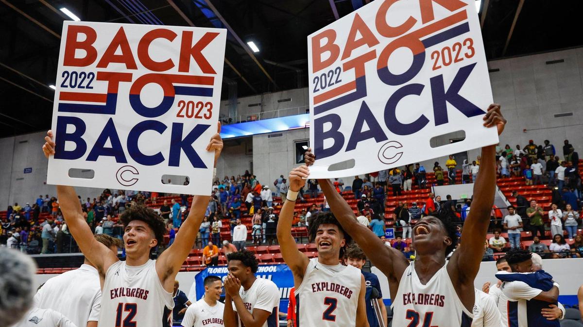 Columbus High School’s Cameron Boozer (12), Cayden Boozer (2), and Malik Abdullahi (24) celebrate their back to back State Titles during the FHSAA boys basketball Class 7A State Championship at the RP Funding Center in Lakeland, Florida on Saturday, March 4, 2023.