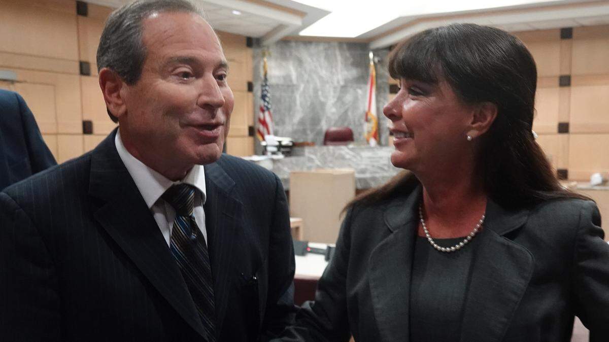 Former Hallandale Beach Mayor Joy Cooper leaves the courtroom at the Broward County Courthouse with her husband, Dr. Harry Cooper, on Tuesday after testimony concluded but before the jury reached a verdict.