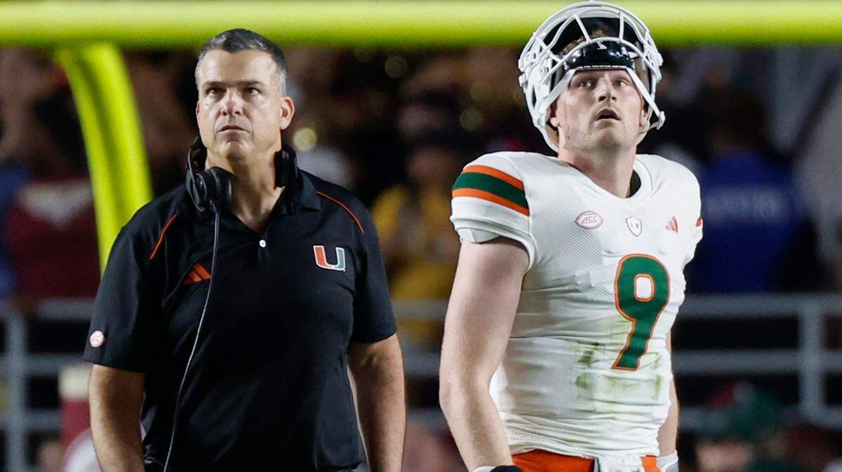 Miami Hurricanes head coach Mario Cristobal and quarterback Tyler Van Dyke (9) wait for the call by the officials in the final seconds of the game against the Florida State Seminoles at Doak Campbell Stadium in Tallahassee on Saturday, November 11, 2023.