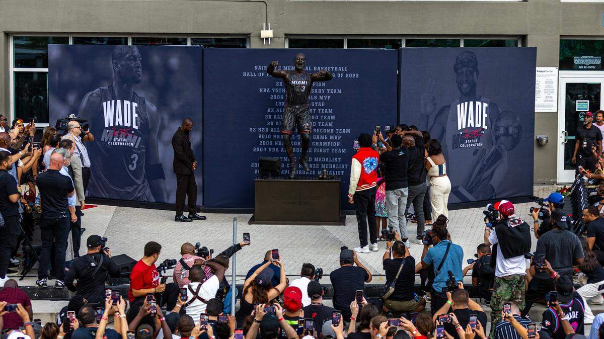Heat icon Dwyane Wade reacts to his statue unveiling during a ceremony outside of the Kaseya Center on Sunday, October 27, 2024, in Miami, Fla.