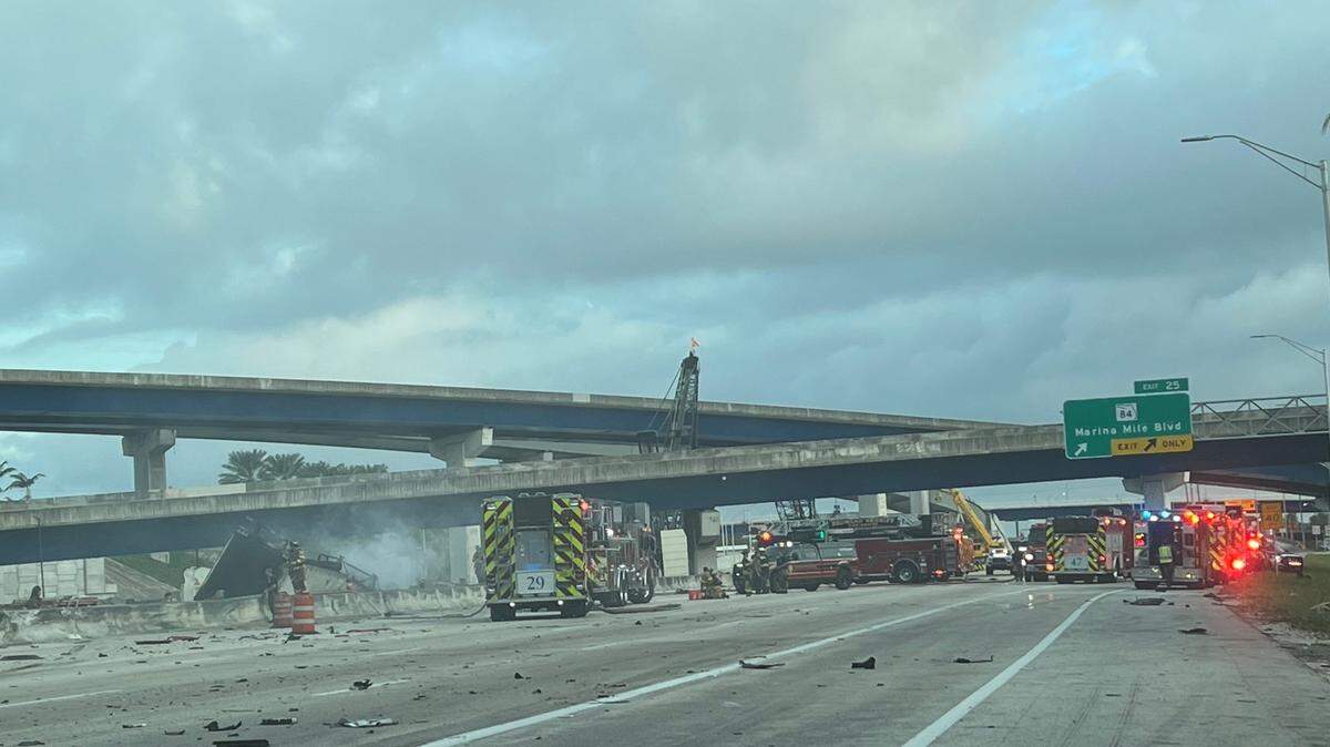 Vehicle parts are strewn across the northbound lanes of I-95 in Fort Lauderdale Friday, Nov. 24, 2023, after a tractor trailer crashed into a construction site on the highway.