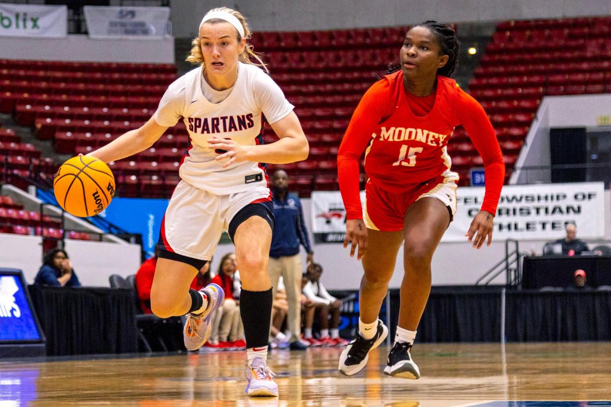 Miami Country Day guard Kristina Godfrey (3) dribbles past Cardinal Mooney guard Sy’monique Simon (15) during the Class 3A state Girl’s basketball championship game at RP Funding Center in Lakeland, Florida, on Saturday, February 25, 2023.