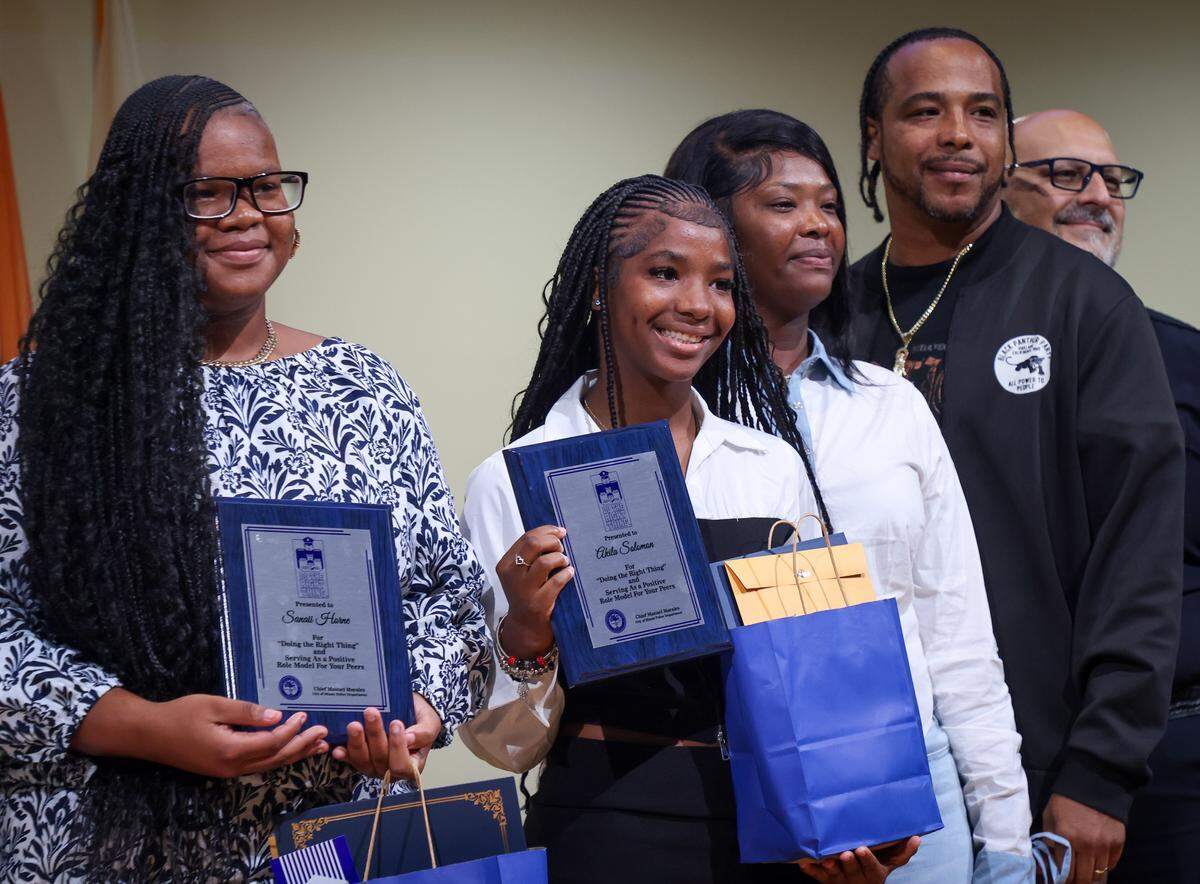 Award recipients Sanaii Horne and Akila Solomon pose with family after receiving the Do the Right Thing award. The Do The Right Thing Program and Miami Police honored nine outstanding students out of over 700 nominees for their courage, compassion, and leadership inside the auditorium of the Chief Clarence Dickson Police College on Wednesday, January 21, 2026, in Miami, Florida. 
