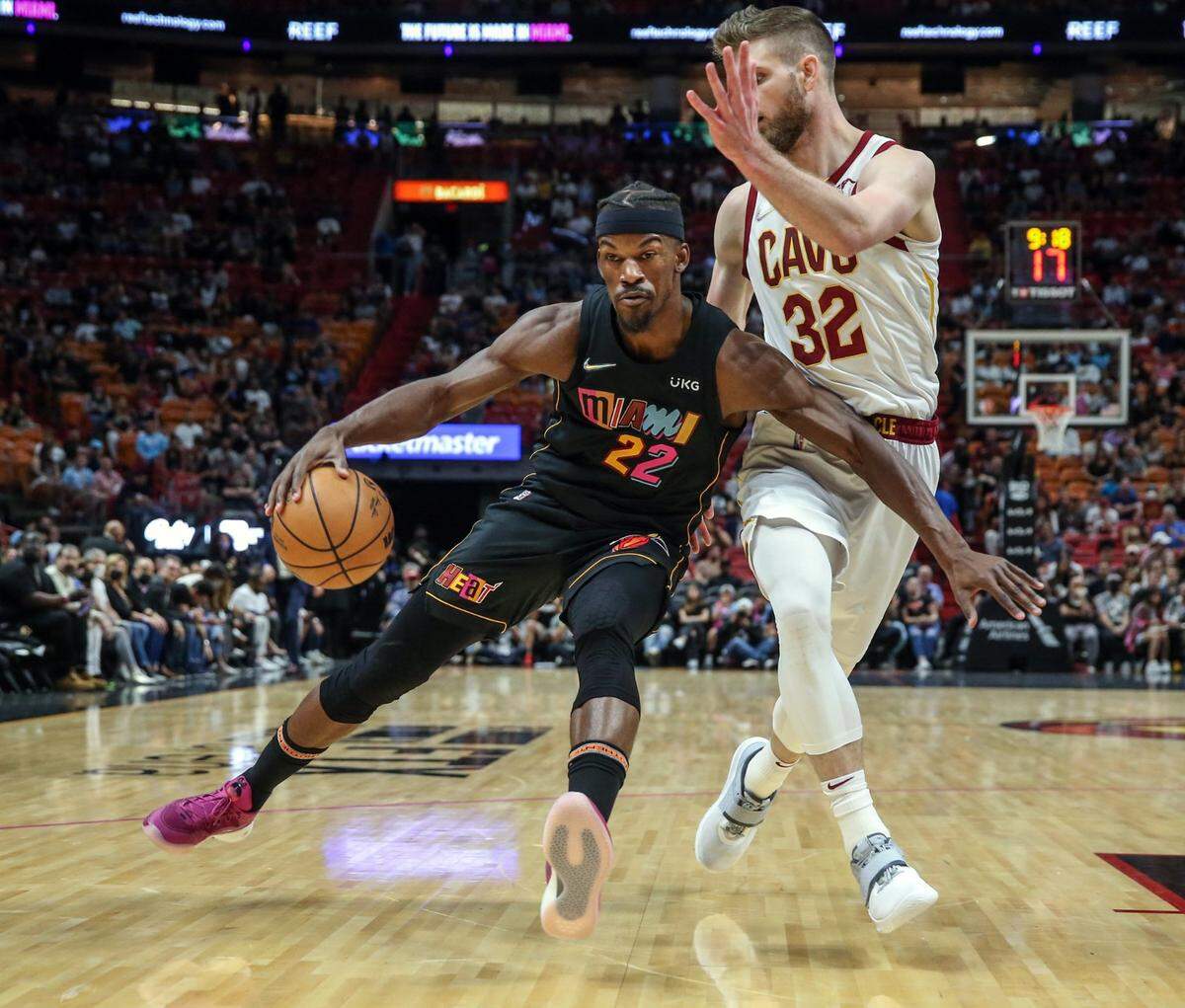 Miami Heat forward Jimmy Butler (22) drives the ball as Cleveland Cavaliers forward Dean Wade (32) defends in the first half at the FTX Arena in Miami on Friday, March 11, 2022.
