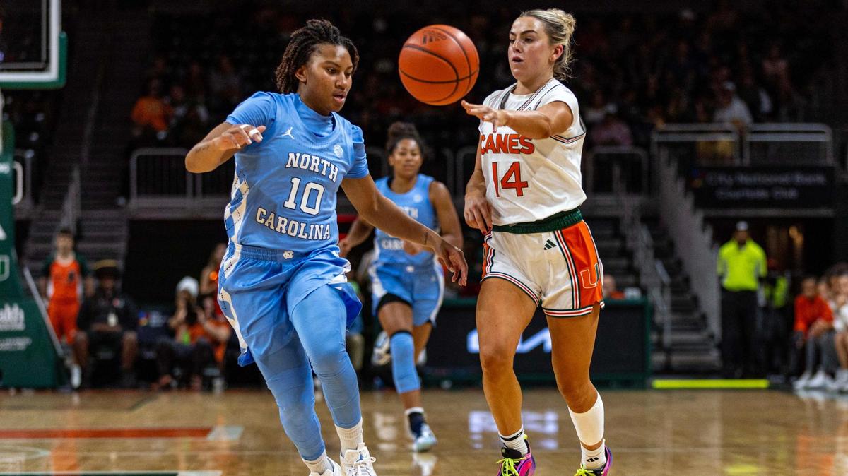 Miami Hurricanes guard Haley Cavinder (14) passes the ball while defended by North Carolina Tar Heels guard Reniya Kelly (10) during the first half of an NCAA women’s basketball game at the Watsco Center on Sunday, Dec. 29, 2024, in Coral Gables, Fla.