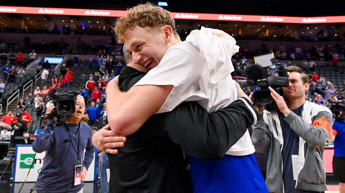 Mar 5, 2023; St. Louis, MO, USA; Drake Bulldogs guard Tucker DeVries (12) celebrates with head coach Darian DeVries after defeating the Bradley Braves in the finals of the Missouri Valley Conference Tournament at Enterprise Center. Mandatory Credit: Jeff Curry-USA TODAY Sports