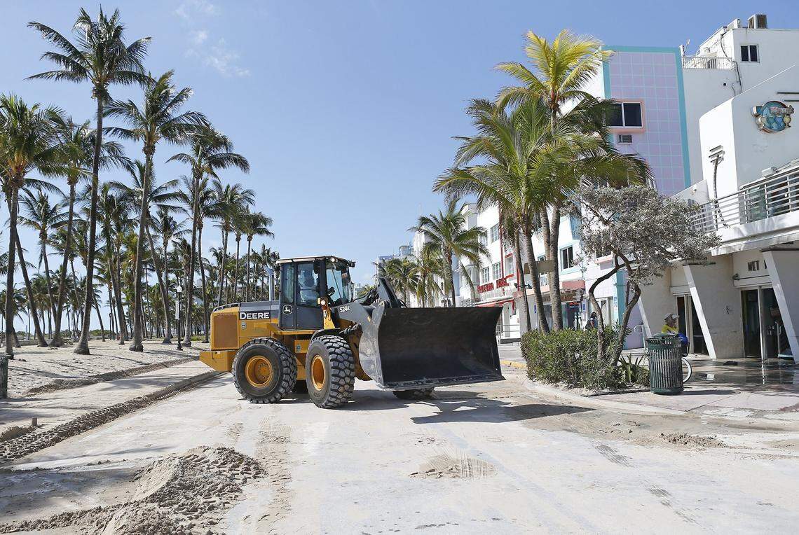 A bulldozer removes beach sand dumped on Ocean Drive in South Beach by storm surge from Hurricane Irma in 2017.