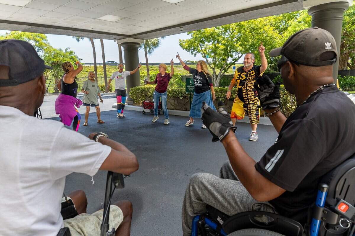 Residents and staff dance together at Miami-Dade Homeless Trust's Hideaway Bay in Cutler Bay, Fla., on Tuesday, June 30, 2026. Hideaway Bay is home to 93 residents and is South Florida's first hotel-to-housing conversion for seniors experiencing homelessness