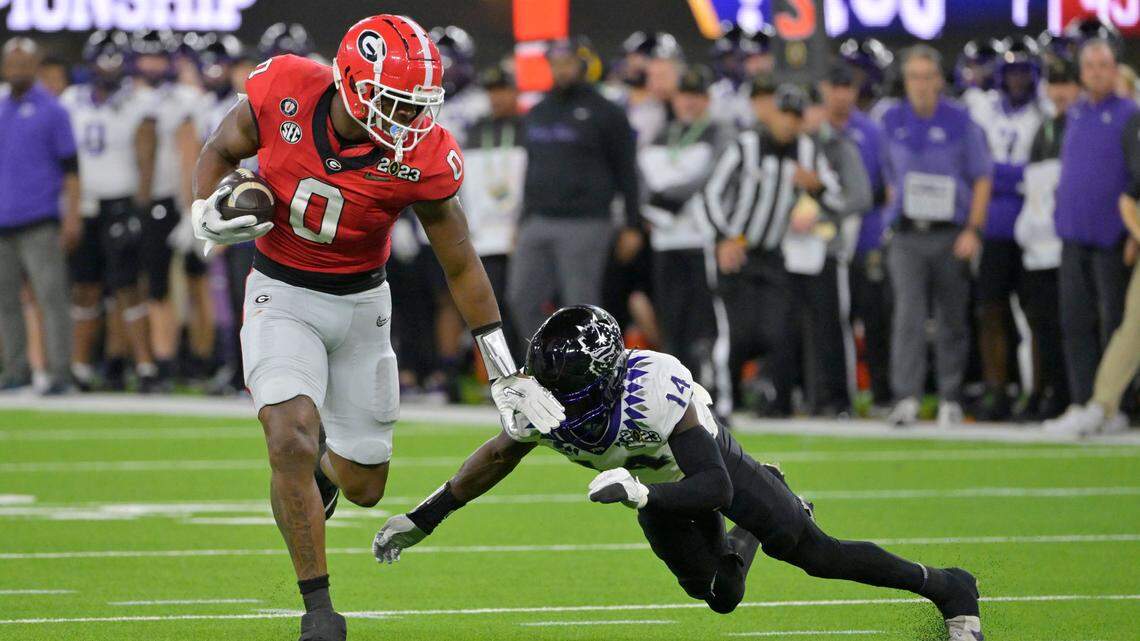 Jan 9, 2023; Inglewood, CA, USA; Georgia Bulldogs tight end Darnell Washington (0) runs the ball against TCU Horned Frogs safety Abraham Camara (14) during the second half in the CFP national championship game at SoFi Stadium. Mandatory Credit: Jayne Kamin-Oncea-USA TODAY Sports