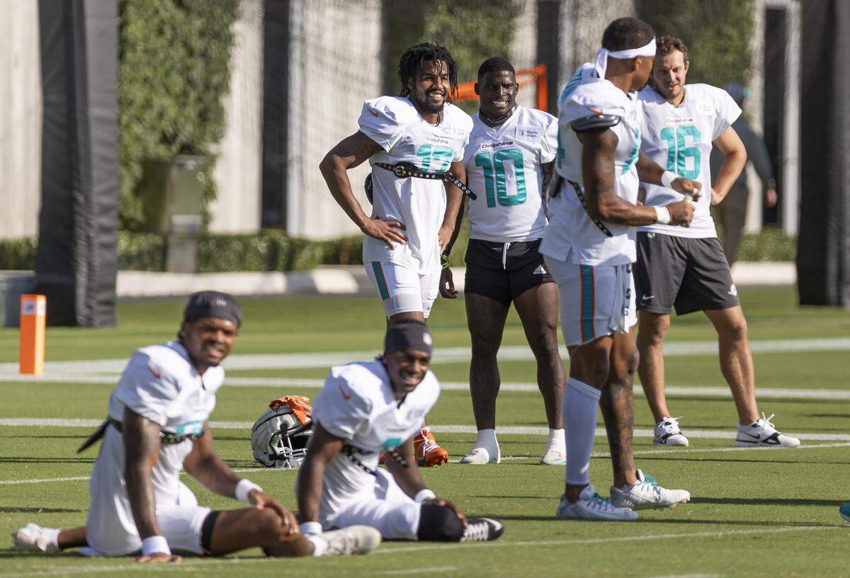 Miami Dolphins wide receivers Jaylen Waddle (17) and Tyreek Hill (10) as they prepare to stretch during training camp at the Baptist Health Training Complex on Tuesday, July 29, 2025, in Miami Gardens, Fla.