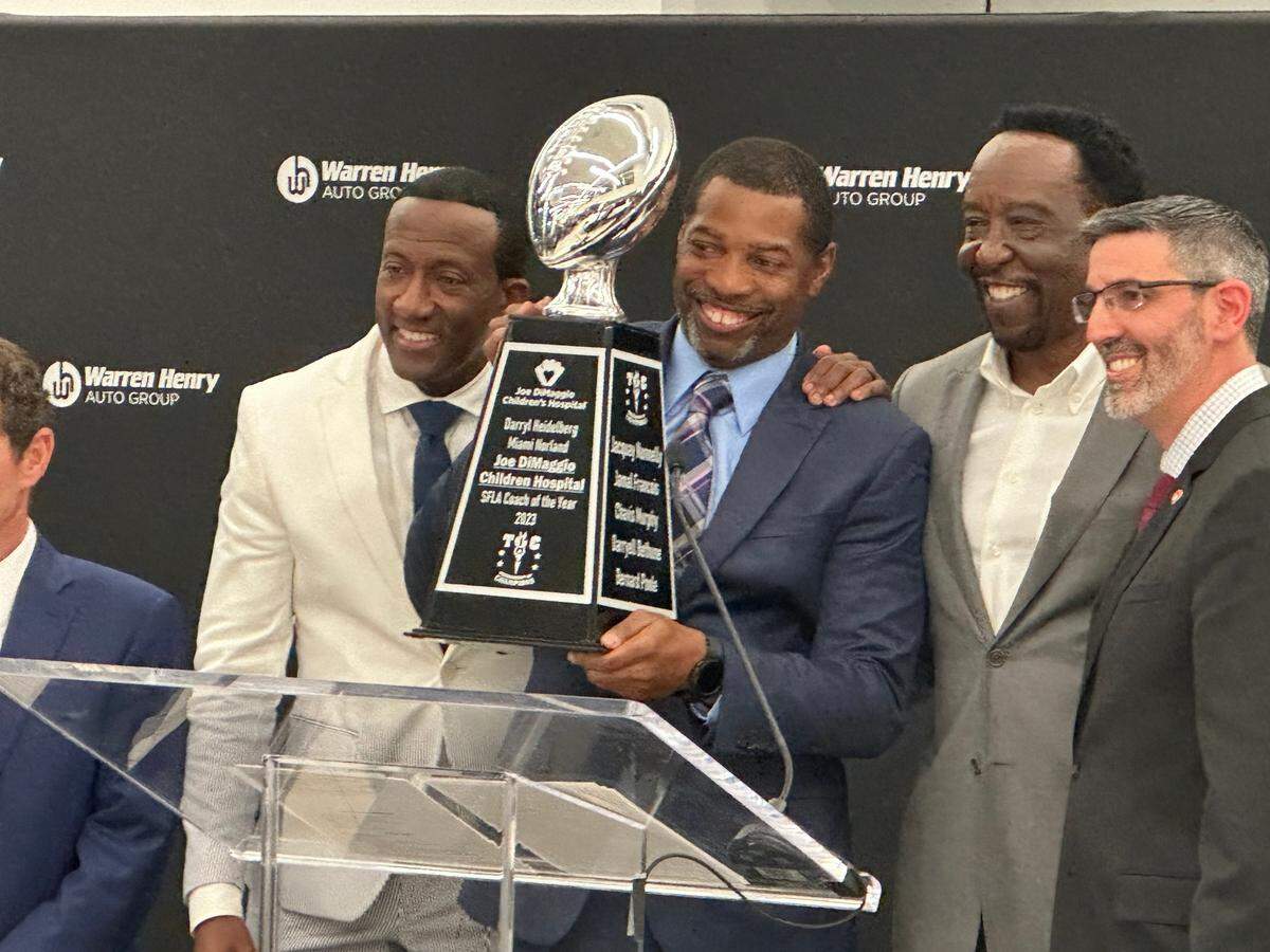 Miami Norland coach Daryle Heidelburg is honored with the Warren Henry Auto South Florida Coach of the Year award during a ceremony on Wednesday night at the Warren Henry Auto dealership in North Miami Beach.