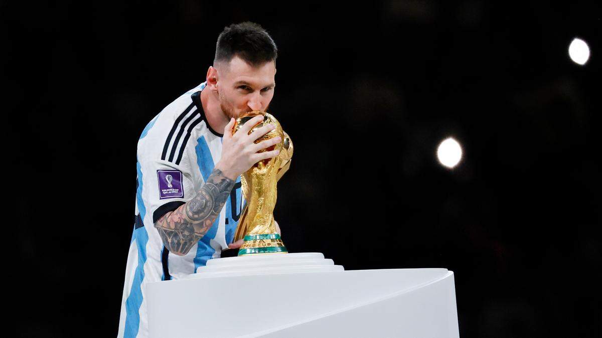 Dec 18, 2022; Lusail, Qatar; Argentina forward Lionel Messi (10) kisses the World Cup Trophy after winning the 2022 World Cup final against France at Lusail Stadium. Mandatory Credit: Yukihito Taguchi-USA TODAY Sports