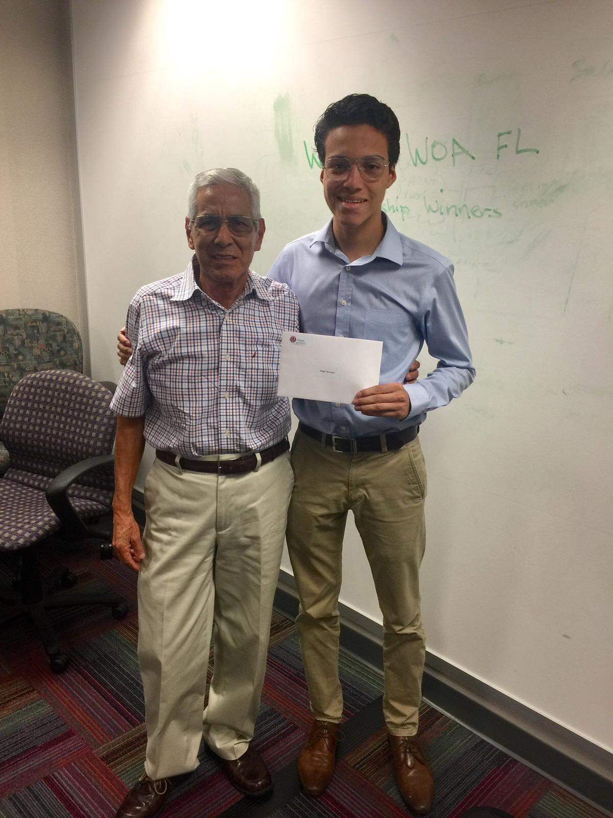The Florida chapter of Women of AT&T awarded Diego Torrejon, right, with a $500 scholarship based on his academic performance and community service. The Archimedean Upper Conservatory alumnus is pictured with his grandfather, Manual Torrejon, left.