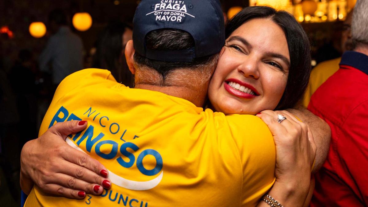 Nicole Reinoso is embraced by a supporter after learning she won the runoff election for seat 3 on the Doral City Council during a watch party at Chabella Mexican Cantina on Tuesday, Dec. 10, 2024, in Doral, Fla.
