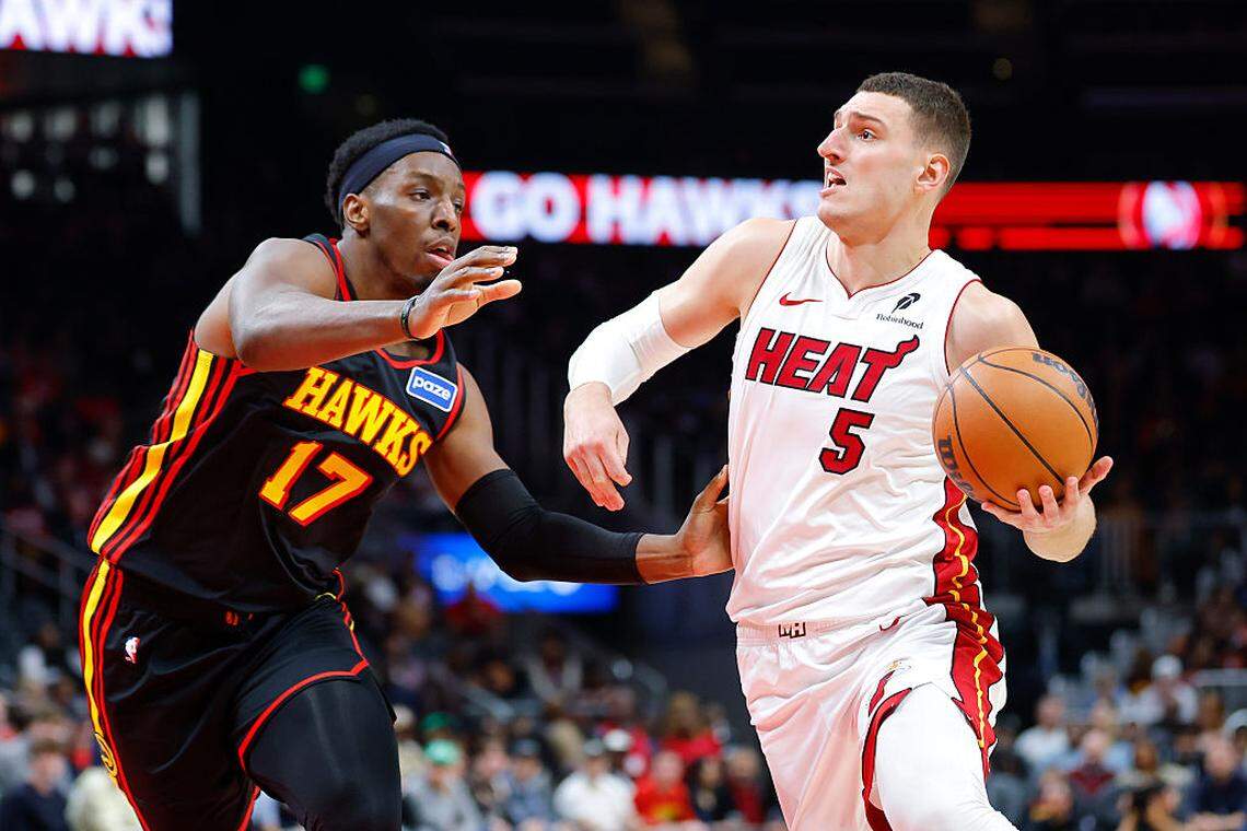 Nikola Jovic #5 of the Miami Heat drives against Onyeka Okongwu #17 of the Atlanta Hawks during the first quarter at State Farm Arena on December 26, 2025 in Atlanta.