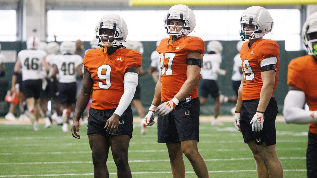 Tight ends Elija Lofton (9), Alex Bauman (87) and Brock Schott (19) wait for a drill to start during Miami Hurricanes football practice on Wednesday, Aug. 6, 2025, at University of Miami in Coral Gables, Fla. 
