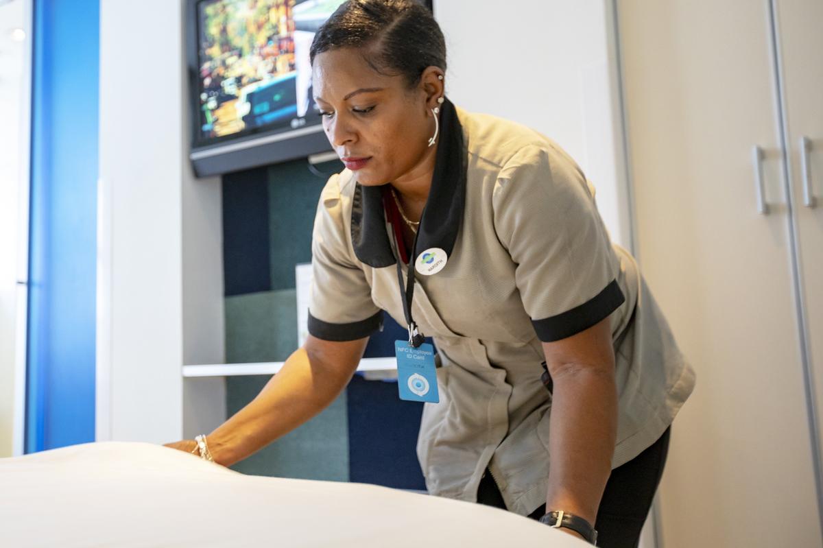 Clevelander Hotel South Beach housekeeper Mardith Wilson makes a bed after guests have left the room in Miami Beach, Florida on Friday, August 8, 2019.