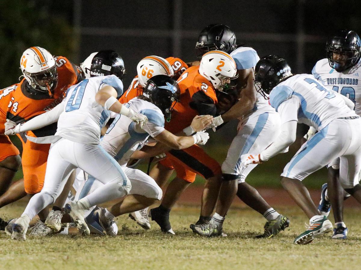 West Broward Bobcats tackle Piper Bengals quarterback Christian Mata (2) during Region 4-6A semifinal football game on Friday, November 22, 2024 at Piper HS in Sunrise. Andrew Uloza / for Miami Herald