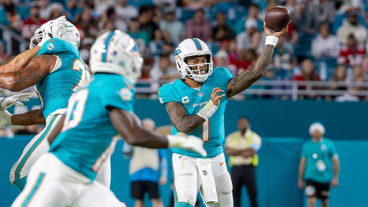 Miami Dolphins quarterback Tua Tagovailoa (1) prepares to pass the ball to wide receiver Tyreek Hill (10) during the second half of their NFL game against the San Francisco 49ers at Hard Rock Stadium on Sunday, Dec. 22, 2024, in Miami Gardens, Florida.