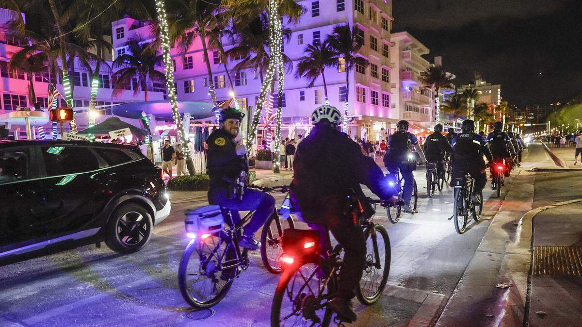 Police officers patrol Ocean Drive during spring break in Miami Beach on Friday, March 20, 2026.