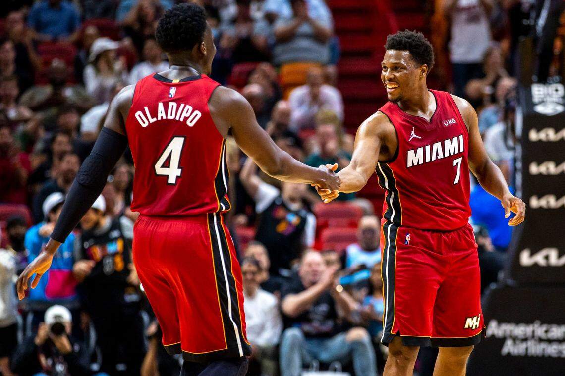 Miami Heat guard Victor Oladipo (4) shakes hands with teammate Kyle Lowry (7) after scoring against the Houston Rockets during the first quarter of an NBA game at FTX Arena in Downtown Miami, Florida, on Monday, March 7, 2022.