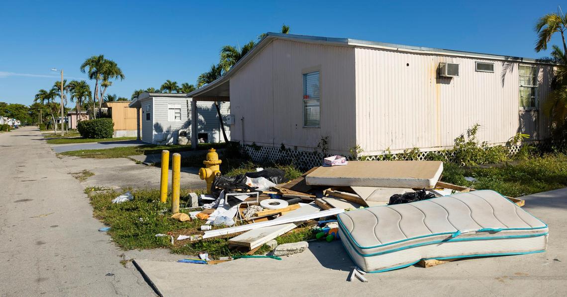 Trash and other belongings are seen piled in front of a home on Northwest Third Terrace in the Li’l Abner Mobile Home Park on Friday, March 7, 2025, in Sweetwater, Florida.