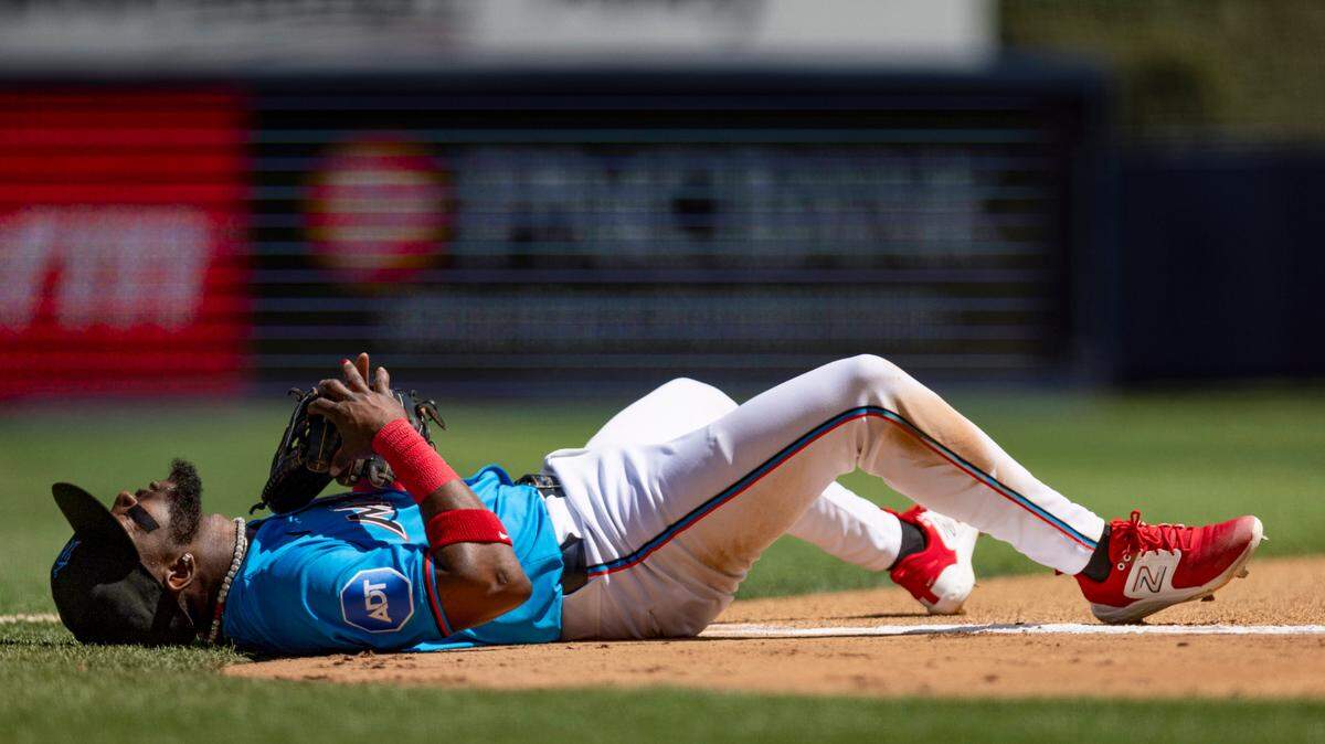 Miami Marlins second baseman Vidal Brujan (17) lays on the ground after a play during the fourth inning of a baseball game against the Pittsburgh Pirates on Sunday, March 31, 2024, at loanDepot Park in Miami.