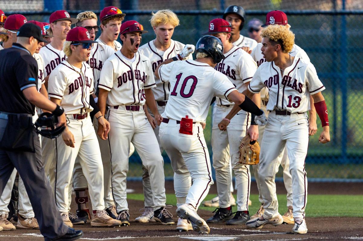 Marjory Stoneman Douglas’ Christian Rodriguez (10) reacts with teammate Alex Rodriguez (13) after homering during the second inning of a high school baseball game against Columbus at Columbus High School in Miami, Florida, on Friday, March 24, 2023.