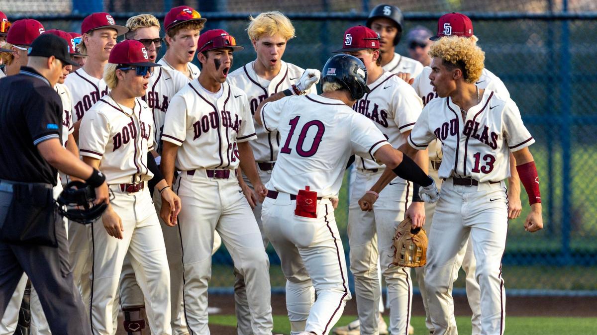 Marjory Stoneman Douglas base runner Christian Rodriguez (10) reacts with teammate Alex Rodriguez (13) after homering during the second inning of a high school baseball game against Columbus at Columbus High School in Miami, Florida, on Friday, March 24, 2023.