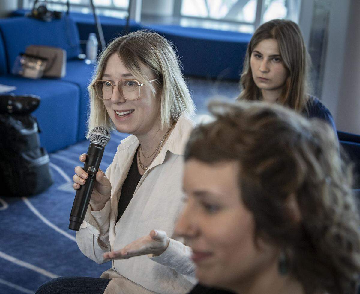 Miami, FL, October 1, 2025 - Miami Herald's climate reporter Denise Hruby asks a question during a discussion titled, Building for the Future: Shaping Climate-Resilience held at the MSC Miami Cruise Terminal in Port Miami. Lead climate reporter Alex Harris, foreground, and multimedia climate reporter Ashley Miznazi, right, rear, also took turns asking questions during the discussion. Inspired by the Herald's ongoing Building for the future series, this discussion featured leaders in development, government, construction and real estate to explore strategies for shaping a climate-resilient South Florida.