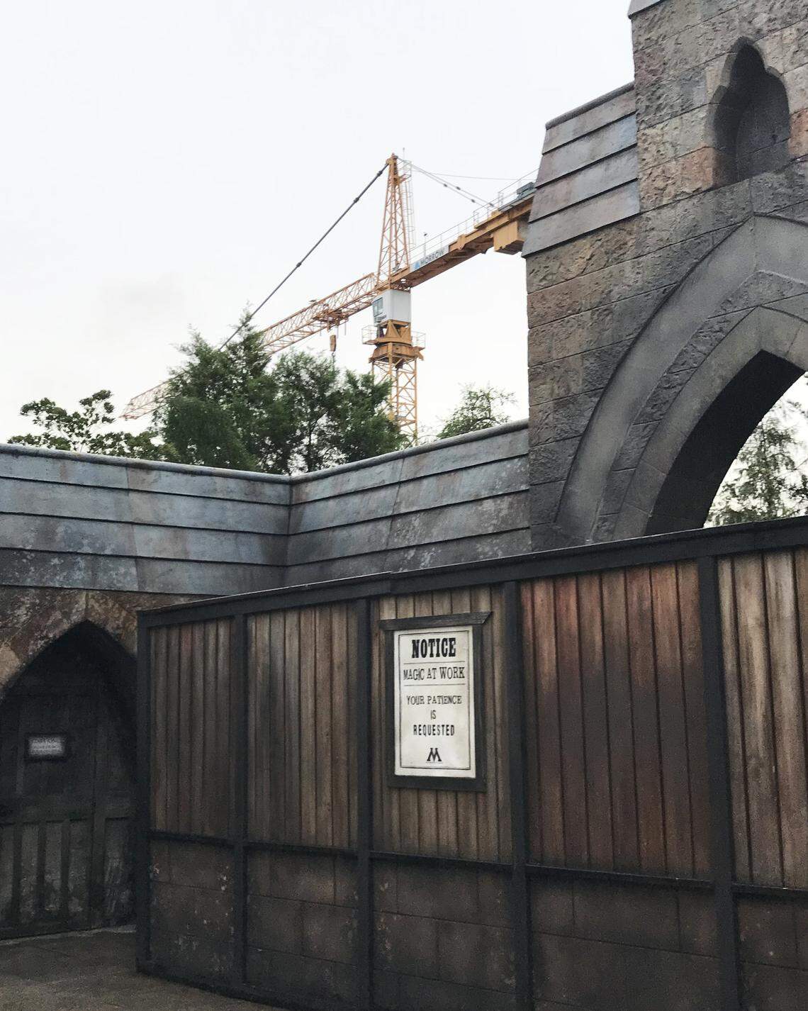 Behind construction walls at Universal’s Islands of Adventure, cranes move sections of track into place for a new Harry Potter-themed roller coaster where the Dragon Challenge coaster once stood.