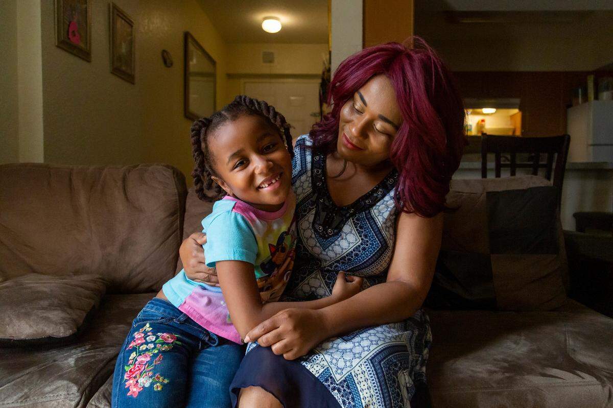 Antonese Dorsin, 37, hugs her daughter Elizabeth Ferguson, 6, at their home in Little Havana, Florida.